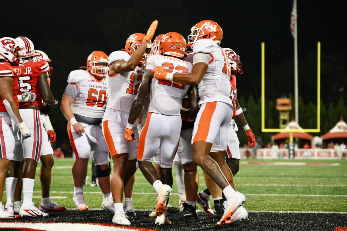 SHSU senior running back Alton McCaskill (22) celebrates with teammates after rushing for a touchdown in last week's loss at Western Kentucky.