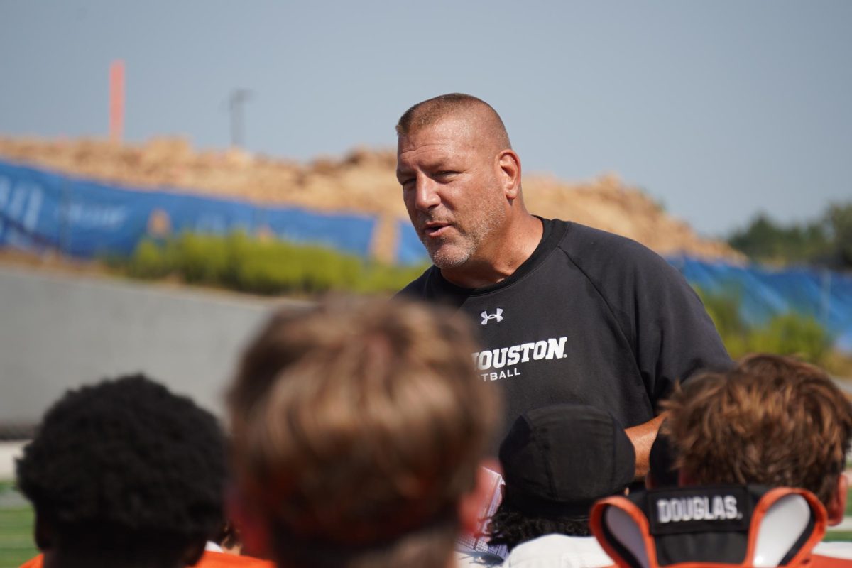 Sam Houston head football coach Phil Longo speaks to his team after a practice in Huntsville.