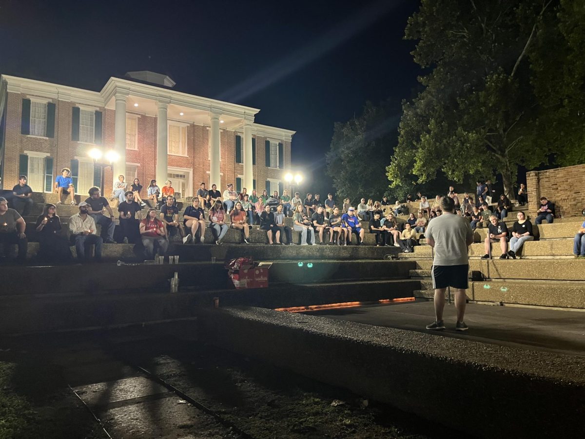 Members of the Huntsville community gather in the Old Main Pit with lit candles on Thursday during a vigil for Turning Point USA founder Charlie Kirk.