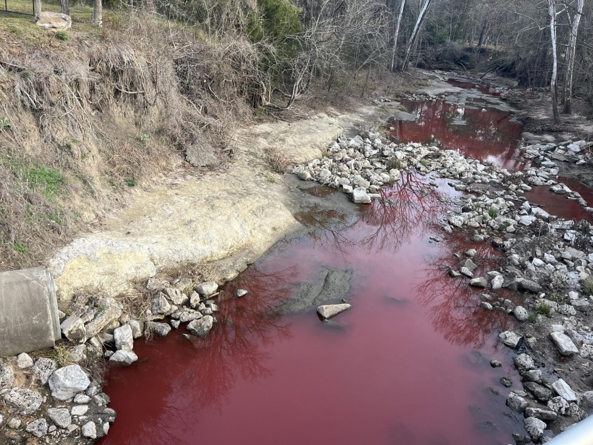 A non-hazardous red dye has been observed in Town Creek.
